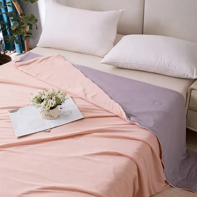 A soft two-toned pink and lavender satin duvet cover for a light blue ice cream air conditioning quilt summer blanket