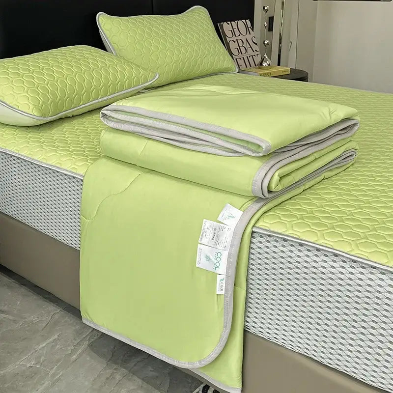 Light green quilt set with gray trim made of ice silk offering decorbites cool feeling bedding for bedroom use