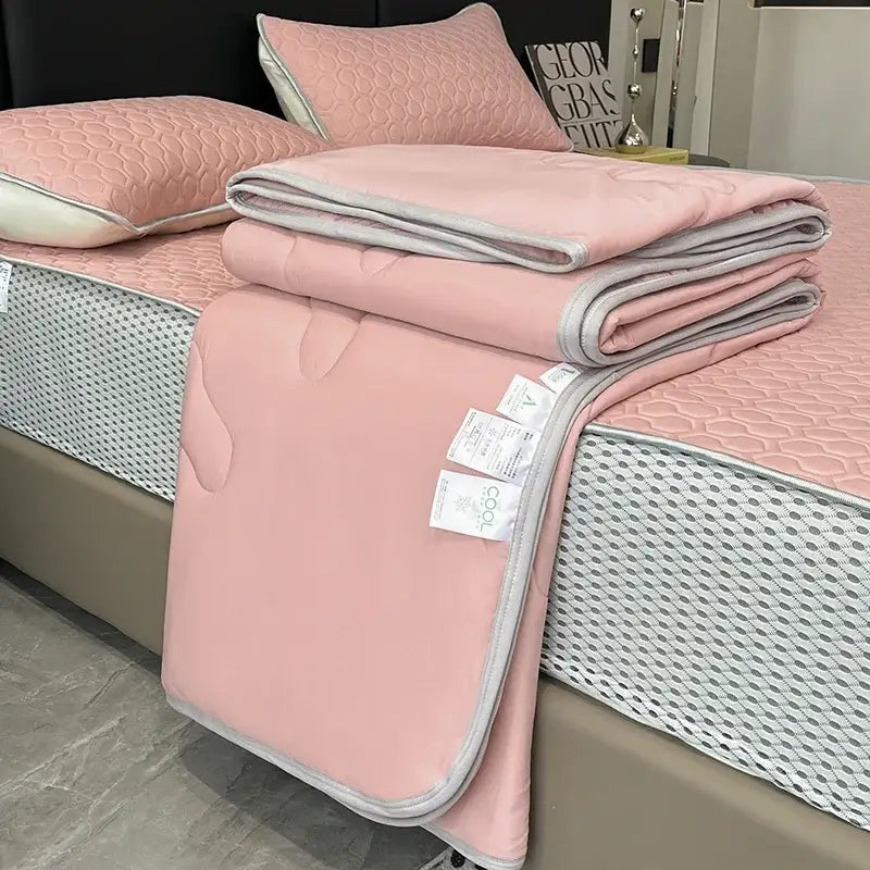 Pink quilted bedspread with gray piping and honeycomb texture in a light blue ice silk quilt set for decorbites cool feeling bedding