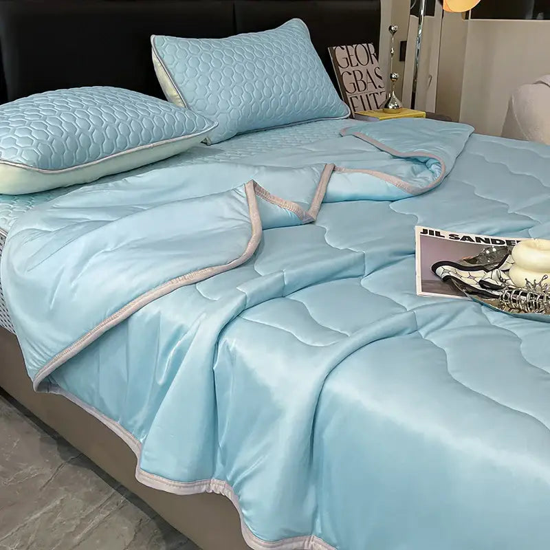 Light blue satin quilt set with subtle gray piping offering decorbites cool feeling ice silk bedding