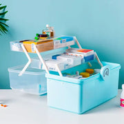 Light blue multifunctional emergency box plastic aid kit with two tiers white foldable handles and circular logo by decorbites household