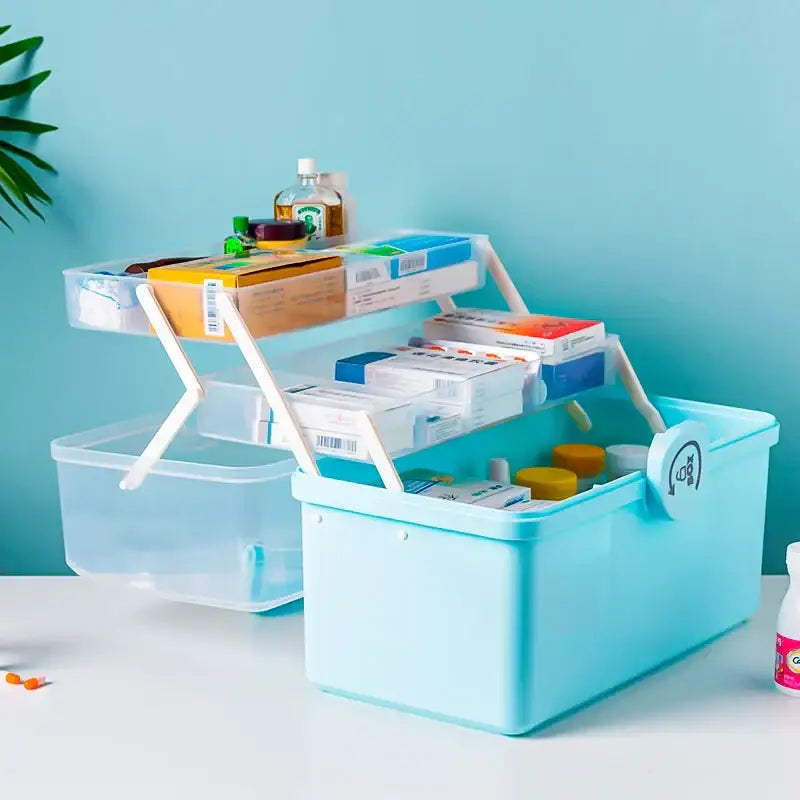 Light blue multifunctional emergency box plastic aid kit with two tiers white foldable handles and circular logo by decorbites household
