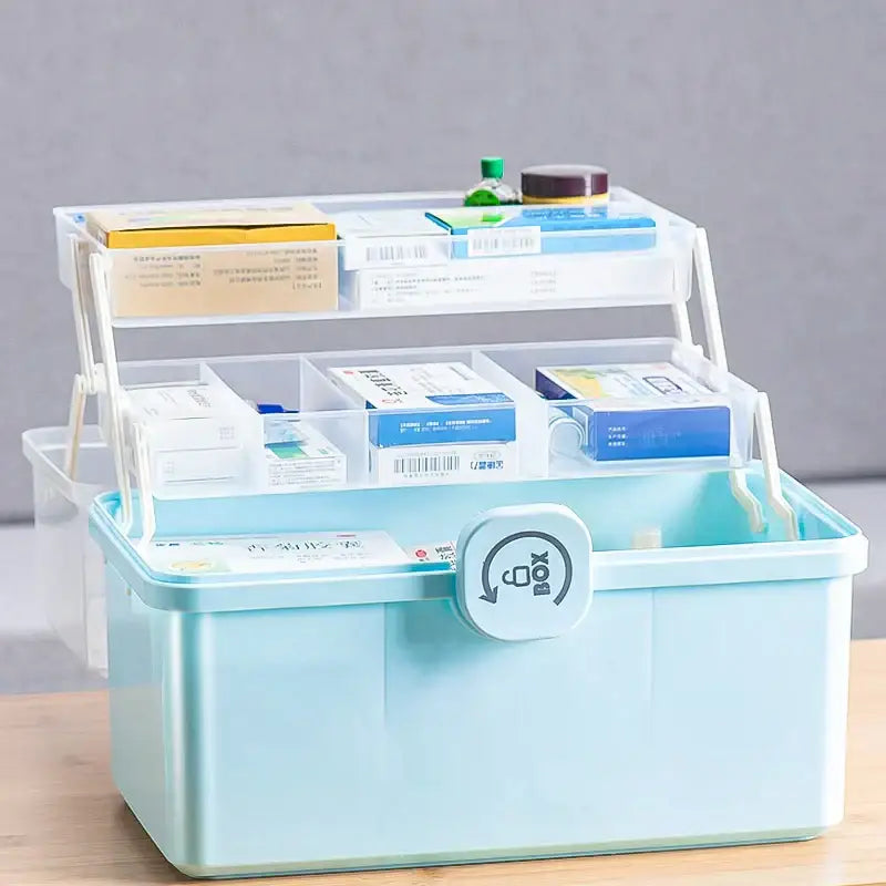 Light blue plastic two-tiered multifunctional emergency box with clear compartments and circular latch for aid kit use
