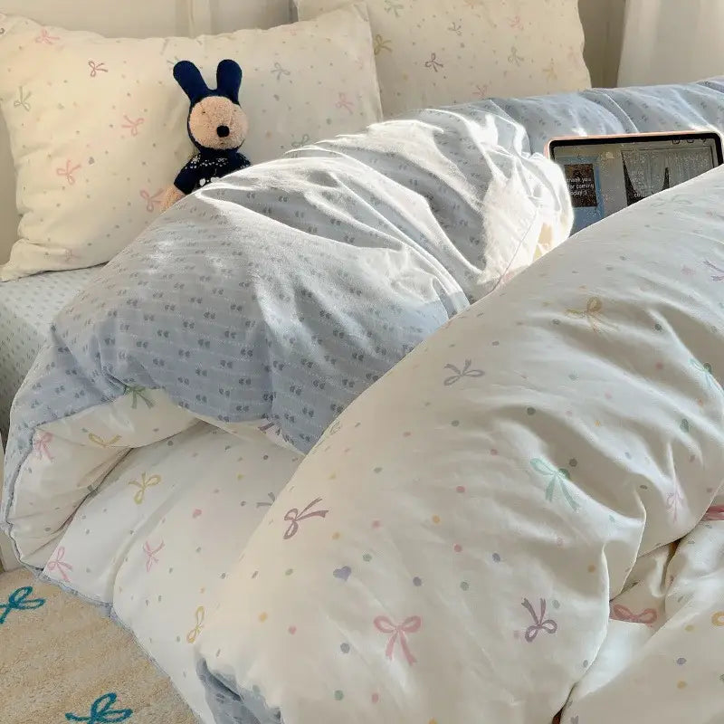 Light blue cotton bedding set with soft pastel cartoon pattern quilt featuring bows and polka dots decorbites cartoon pattern