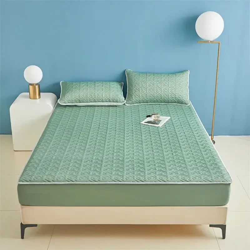 Light blue quilted latex fitted sheet set featuring a mint green quilted bed sheet with subtle geometric pattern and white piping
