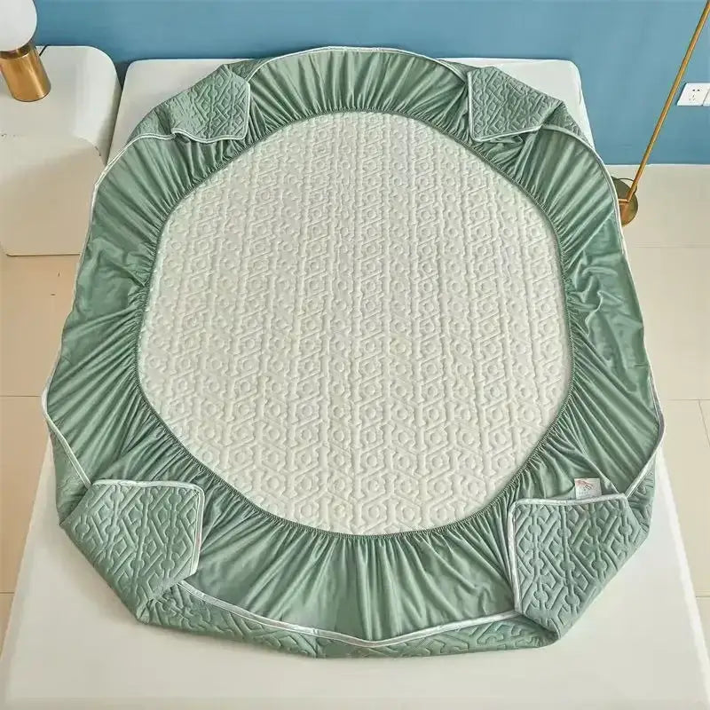 Light blue quilted latex fitted sheet set with mint green quilted fitted sheet featuring white patterned center and elastic edges