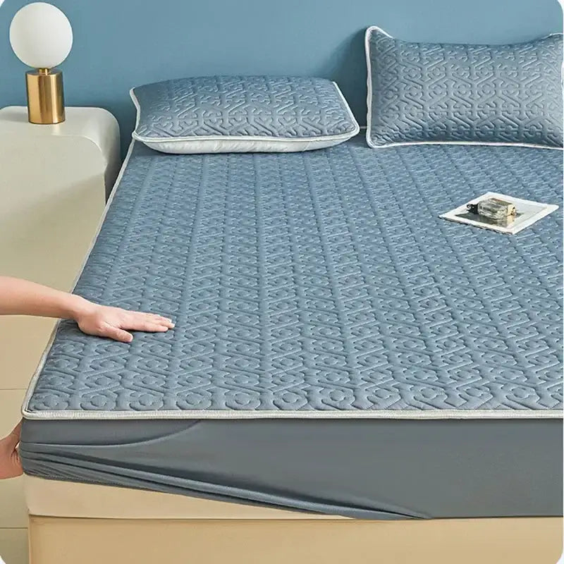 Light blue quilted latex fitted sheet set with subtle geometric pattern and white piping for bedroom use