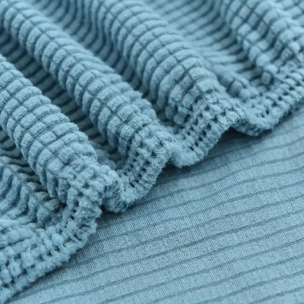 Light blue quilted thicken sofa cover featuring a light blue ribbed fabric with a textured waffle knit pattern decorbites 3d quilted
