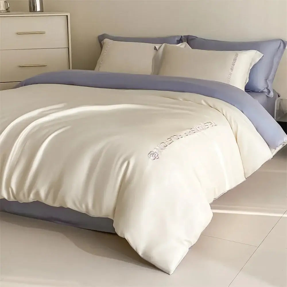 Cream-colored satin duvet cover with lavender trim and floral embroidery in light blue satin cotton embroidery bedding set