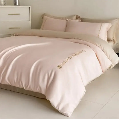 Blush pink satin duvet cover with gold embroidered logo and rose motif in decorbites cotton embroidery bedding set