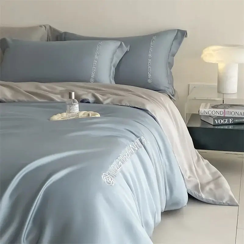 Light blue satin cotton embroidery bedding set with subtle white embroidered text and rose motif for decorbites decor