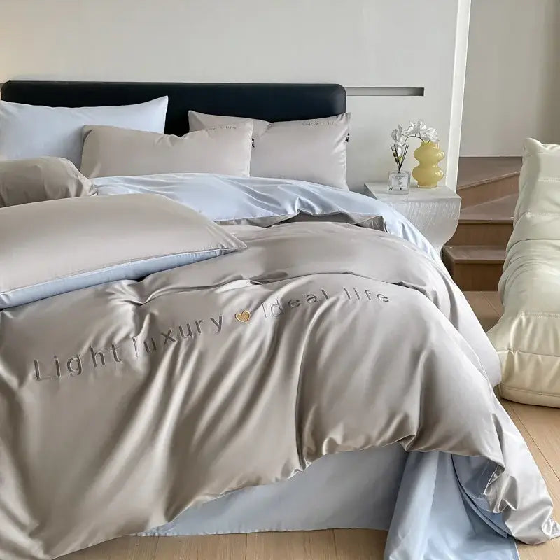 Beige satin embroidery duvet cover with light blue inner lining and light luxury text in decorbites bedding set