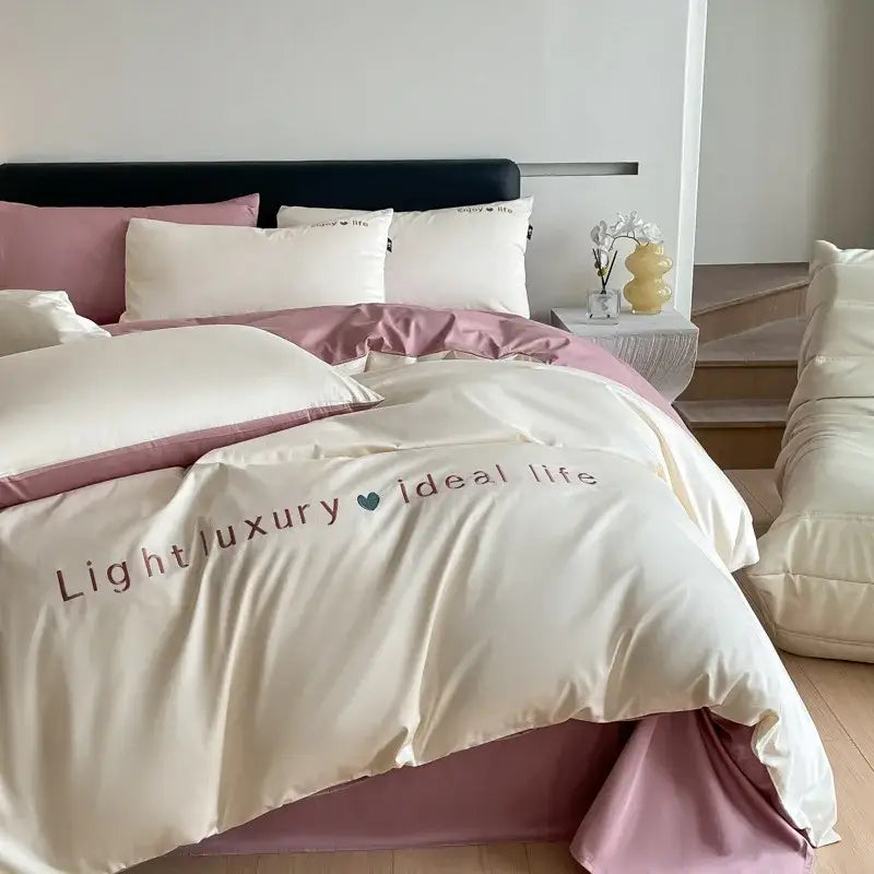 Cream-colored satin embroidery bedding set duvet cover with soft pink border and light luxury ideal life text by decorbites