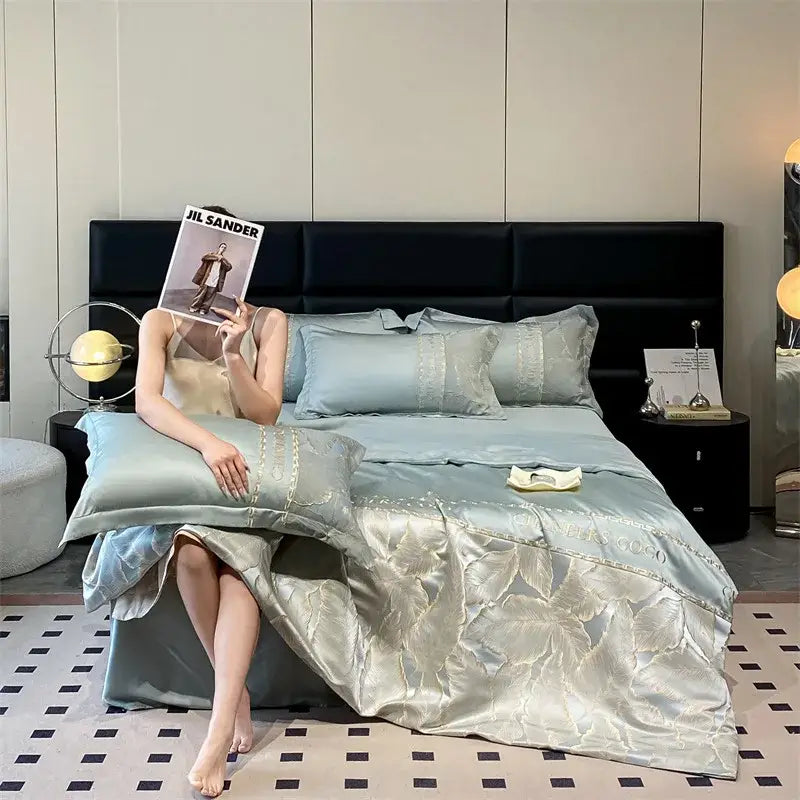 Light blue satin ice silk summer quilt with subtle gold leaf embroidery and matching pillow sham from decorbites ice silk