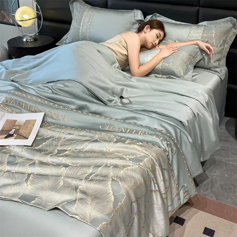 Light blue satin ice silk summer quilt with gold leaf embroidery and chanels coco lettering decorbites ice silk