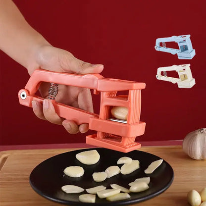 Pink plastic garlic press with metal spring mechanism, a press slicer chopper kitchen tool for easy garlic preparation