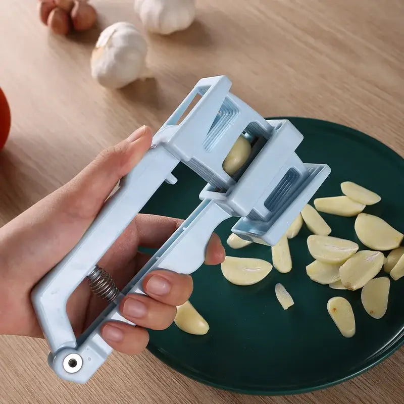 Light blue plastic garlic press slicer with spring loaded adjustable blades for efficient kitchen use