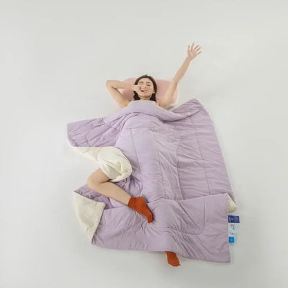 Lavender quilted comforter with cream-colored lining made from decorbites cooling fabric for summer bedroom use