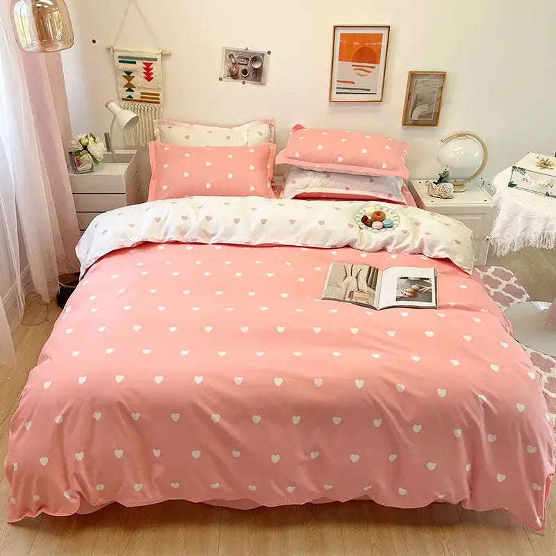 Pink bedding set with heart print and white polka dots complementing light blue and white heart print duvet cover