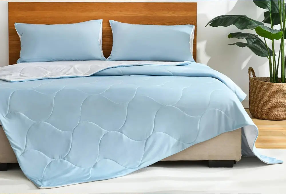Light blue and white quilted cooling comforter with soft smooth texture and subtle wave-pattern stitching by decorbites cooling