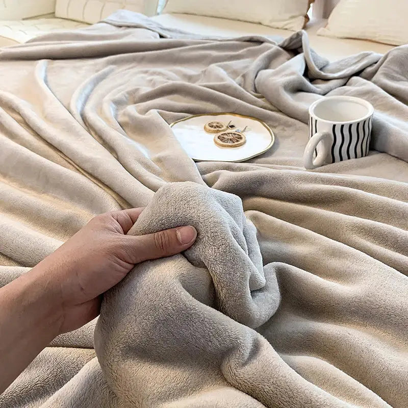 A soft plush beige fleece blanket with a cozy texture for summer blanket decorbites coral velvet throw