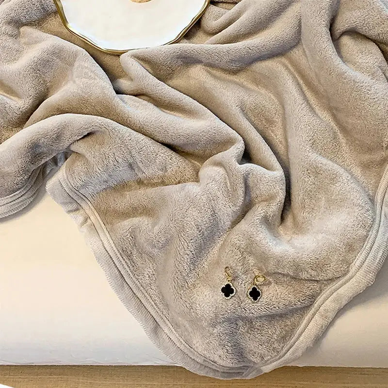 A soft beige plush fleece summer blanket with cozy texture and neatly stitched edges from decorbites coral velvet collection