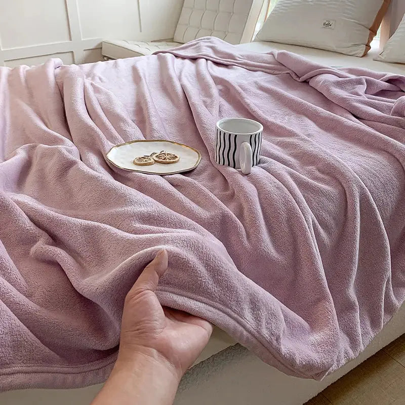 A soft dusty rose coral velvet summer blanket with a textured velvety surface for decorbites plush throw