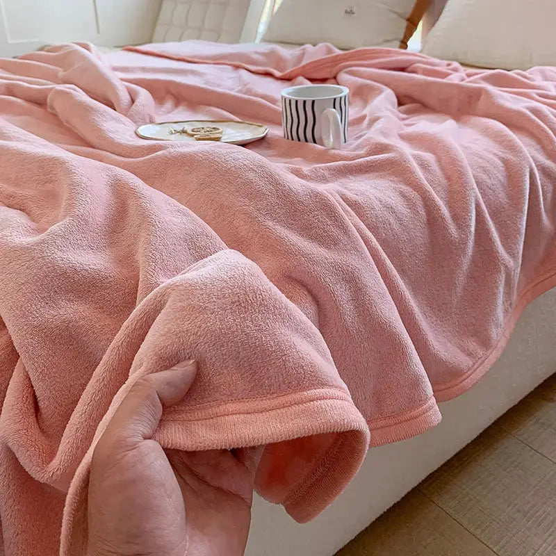 A soft plush pink fleece blanket with cozy texture and finished edges for summer blanket decorbites coral velvet use