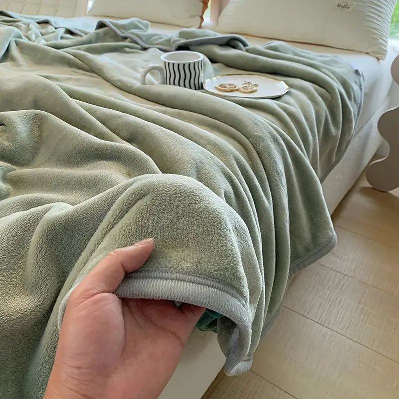 A soft sage green coral velvet summer blanket with plush texture and neatly finished edges by decorbites coral velvet