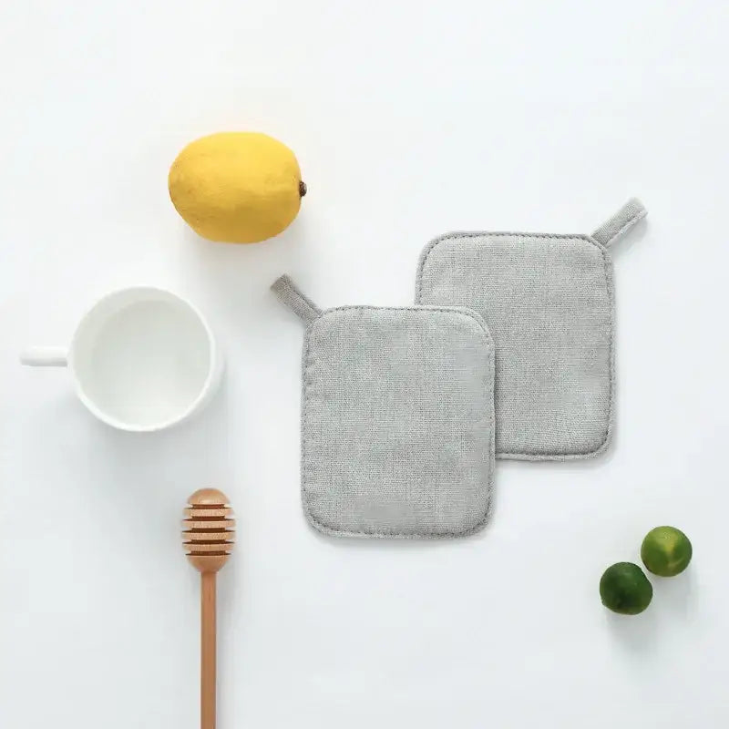 Light gray cotton linen coaster set with handle featuring gray linen potholders with stitched edges and hanging loops by decorbites cotton linen