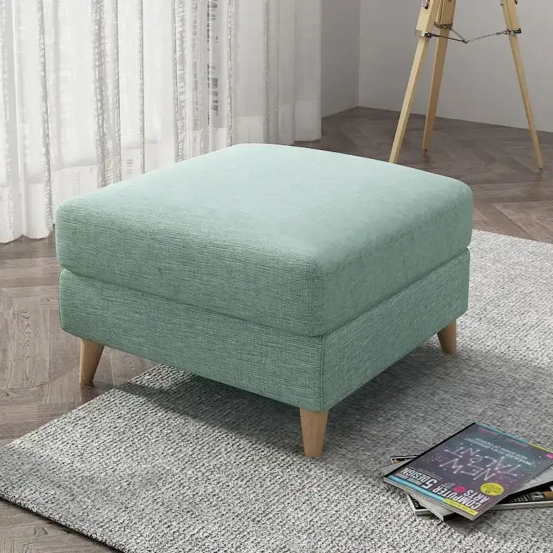 A mint green upholstered ottoman with wooden legs featuring a light gray jacquard square stool cover decorbites jacquard square