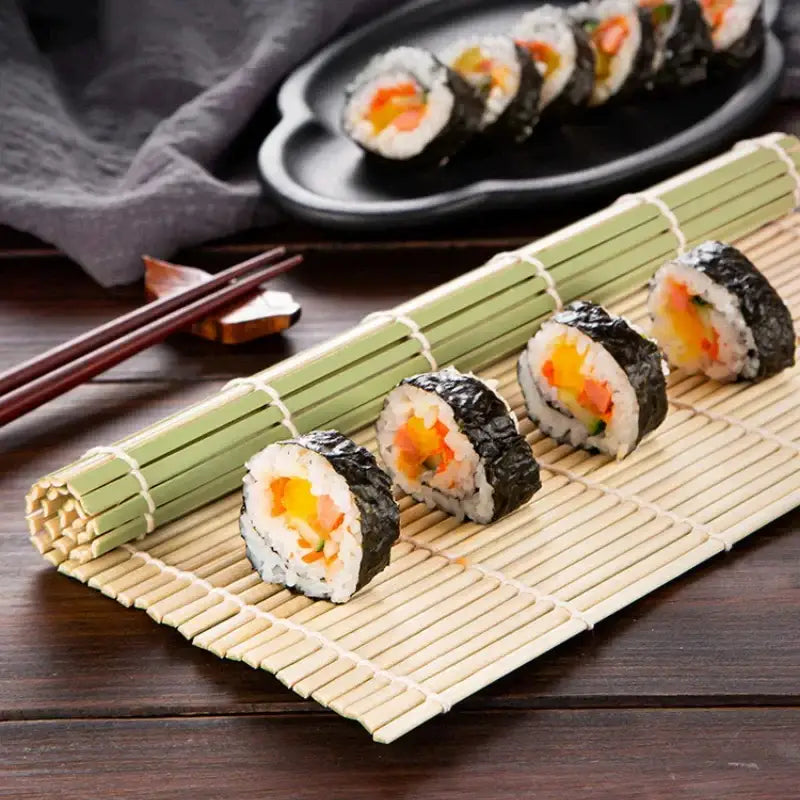 Sliced maki sushi rolls on a light green bamboo sushi rolling mat set made of natural bamboo for kitchen diy sushi rolling