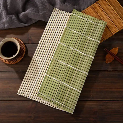 Two bamboo sushi rolling mats in natural beige and light green with white woven bindings for kitchen diy use