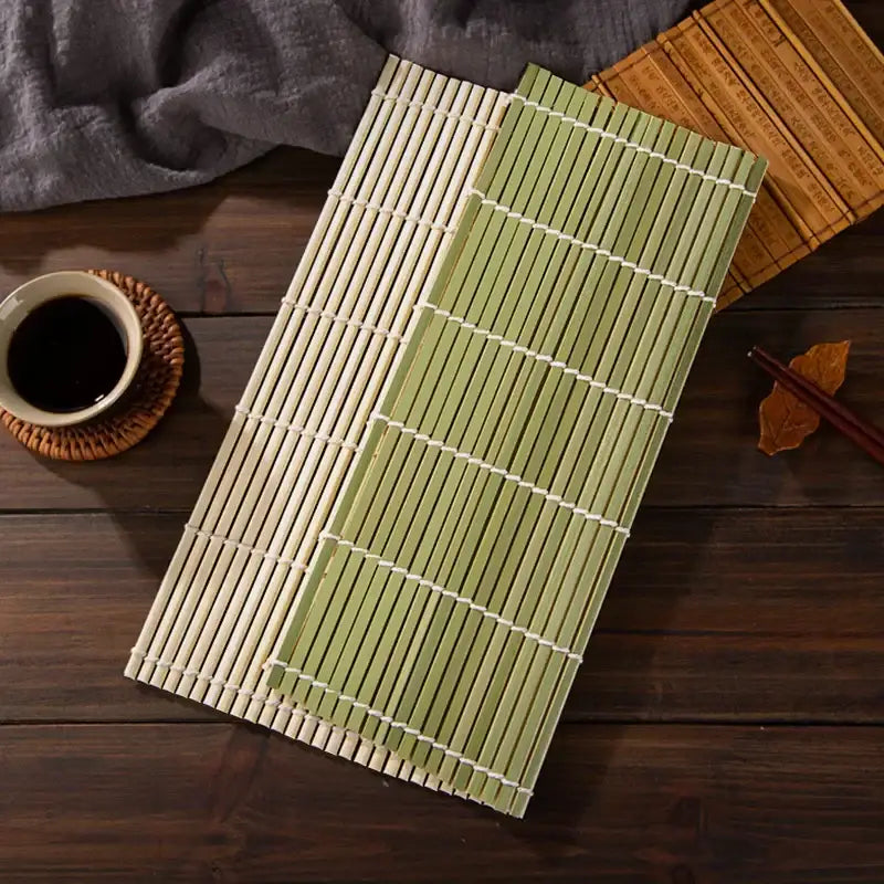Two bamboo sushi rolling mats in natural beige and light green with white woven bindings for kitchen diy use