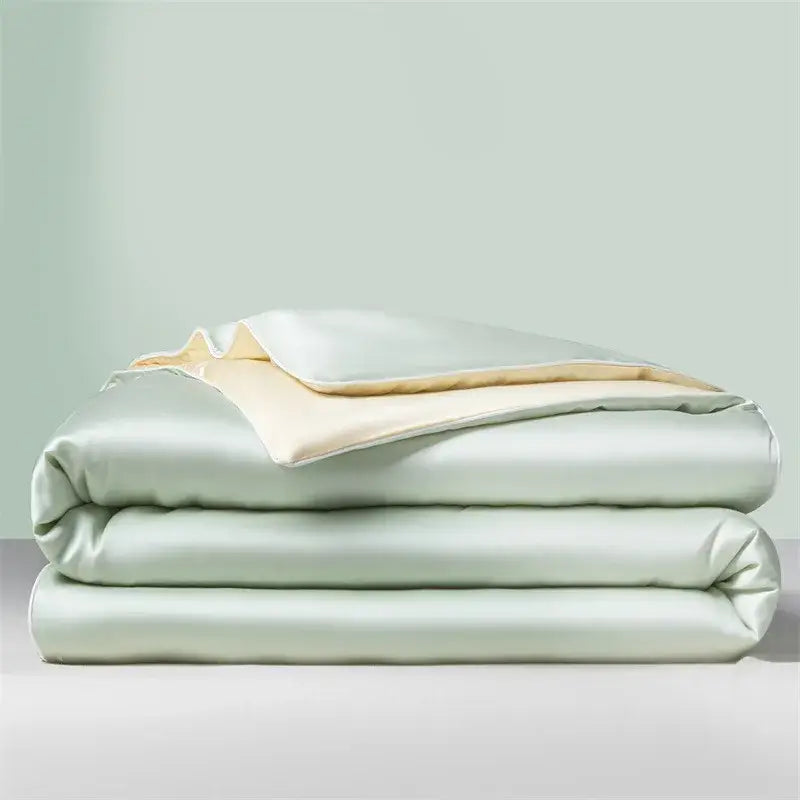 Light green and cream cool ice silk quilt set with a soft satin duvet featuring subtle sheen and cream lining by decorbites
