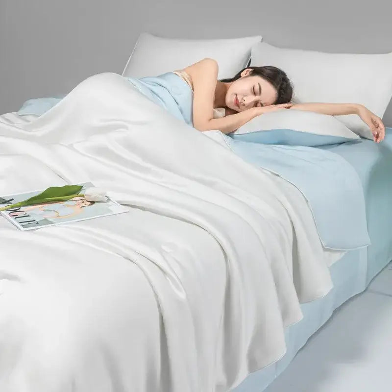 Soft white satin quilt set with light blue accents from decorbites cool ice silk bedroom bedding collection