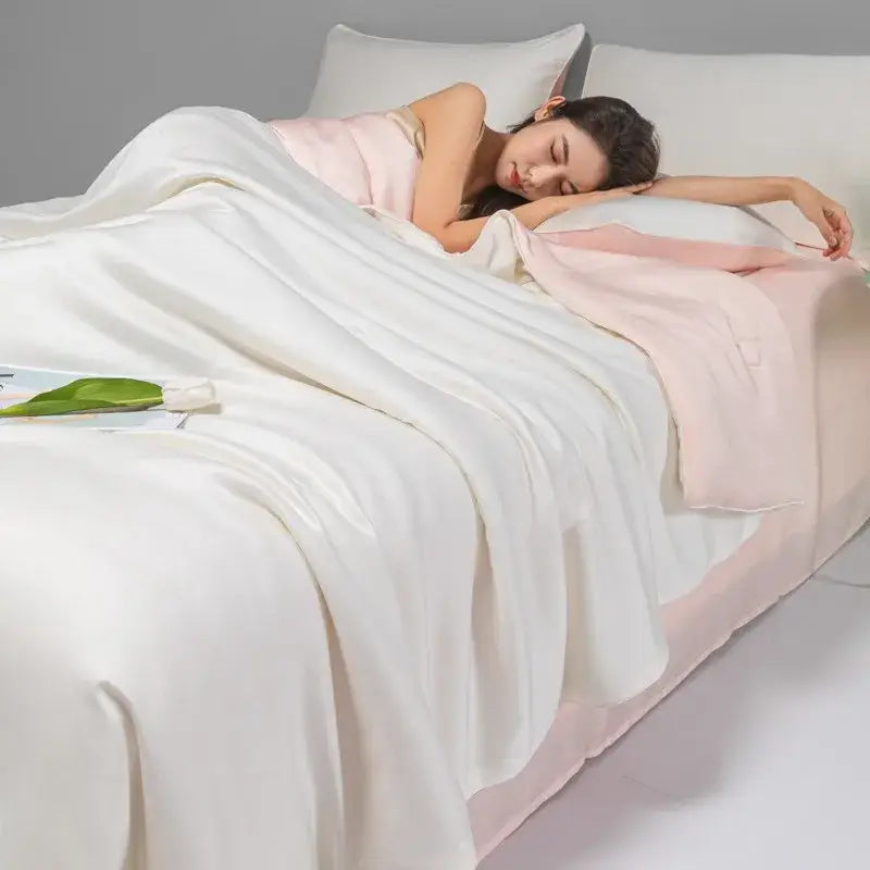 A soft two-toned satin quilt set in white and blush pink from decorbites cool ice silk bedroom bedding