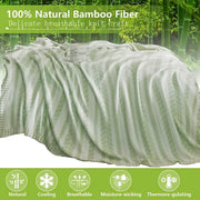 A soft light green decorbites bamboo knitted cooling blanket with a subtle leaf pattern for bedroom use
