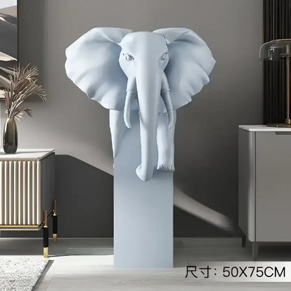 A sleek light blue glossy elephant ornament sculpture with oversized ears on a matching pedestal for living room decorbites elephant ornaments