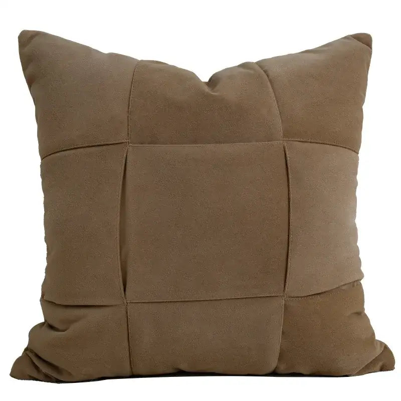 Brown suede pillow cover with quilted grid pattern complementing white light luxury designer living room decor