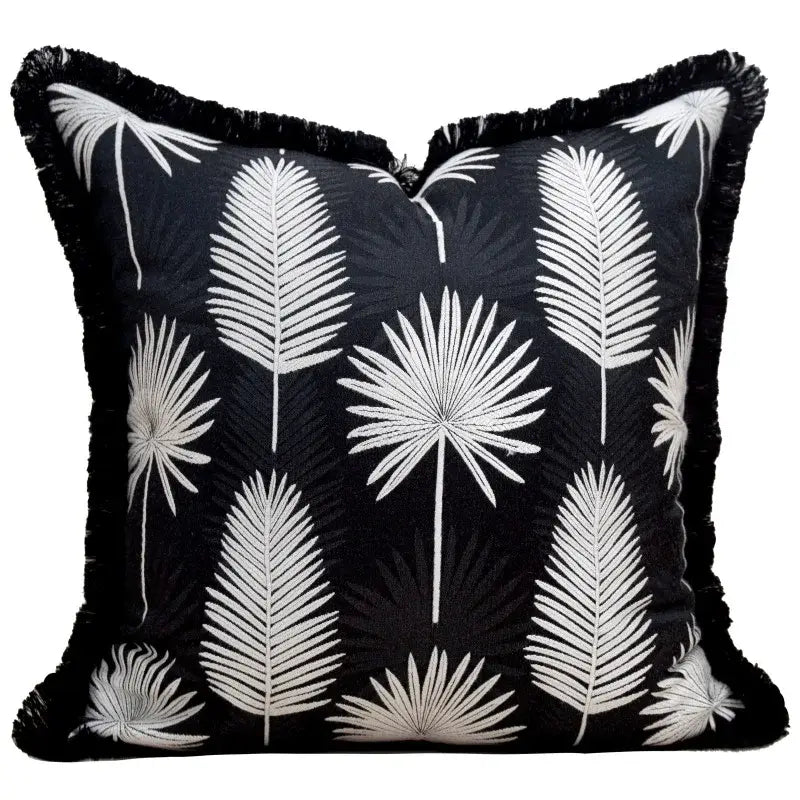 Black throw pillow cover with white embroidered palm fronds and black fringe trim for light luxury designer decor