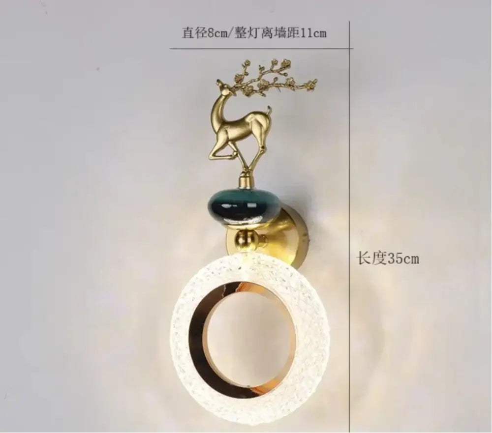 Gold-toned deer wall lamp with branching antlers on dark green ceramic orb and frosted glass shade by decorbites light luxury
