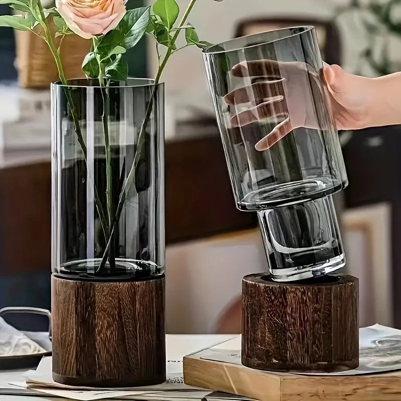 Tall sleek glass vases with dark wood bases in primary colors for living room table decoration and water nourishment