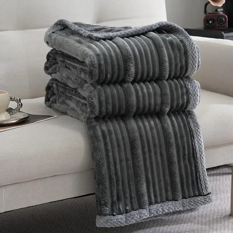 Stacked gray plush luxury sofa blanket with ribbed fleece texture and fuzzy edges from decorbites light luxury collection