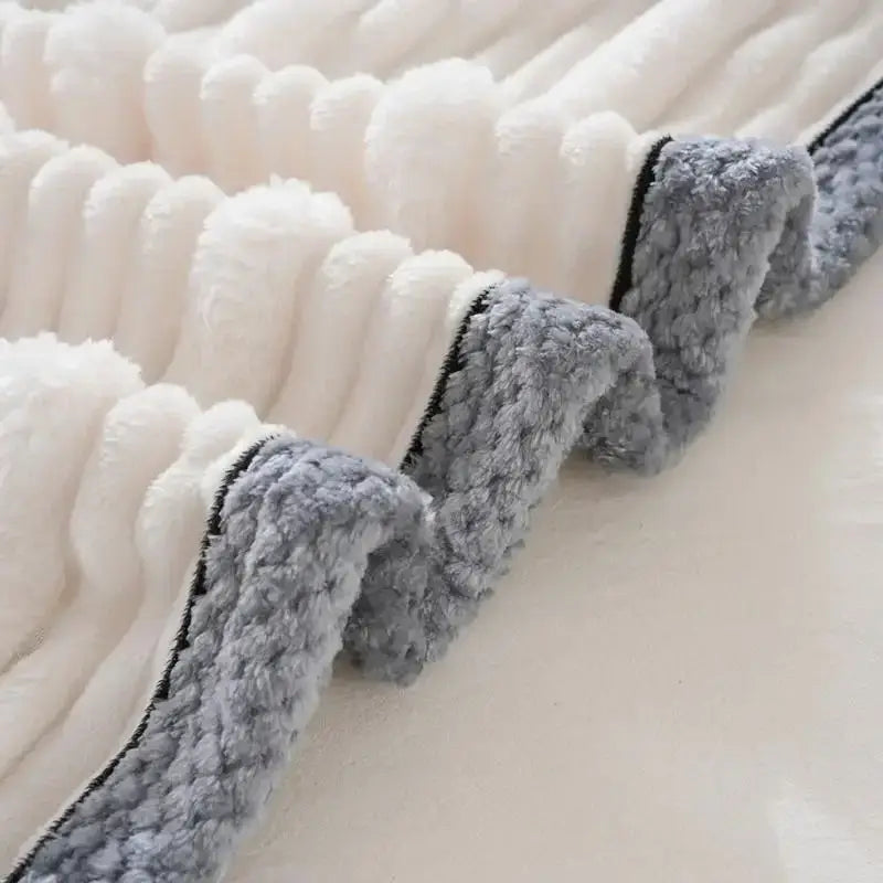 White and gray plush fleece luxury sofa blanket with ribbed texture and black trim for decorbites light luxury decor