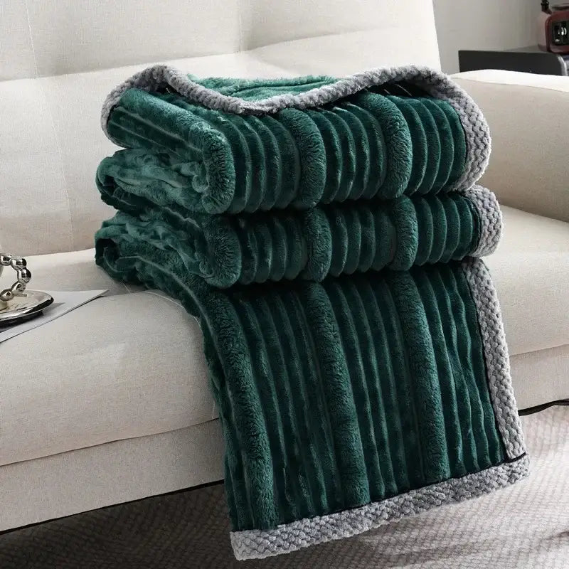 Stacked emerald green corduroy luxury sofa blanket with plush texture and gray knitted border for decorbites light luxury decor