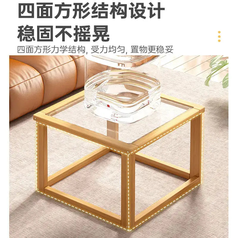 Gold-framed square glass-top side table with illuminated edge lighting in a light wood two tier coffee table set