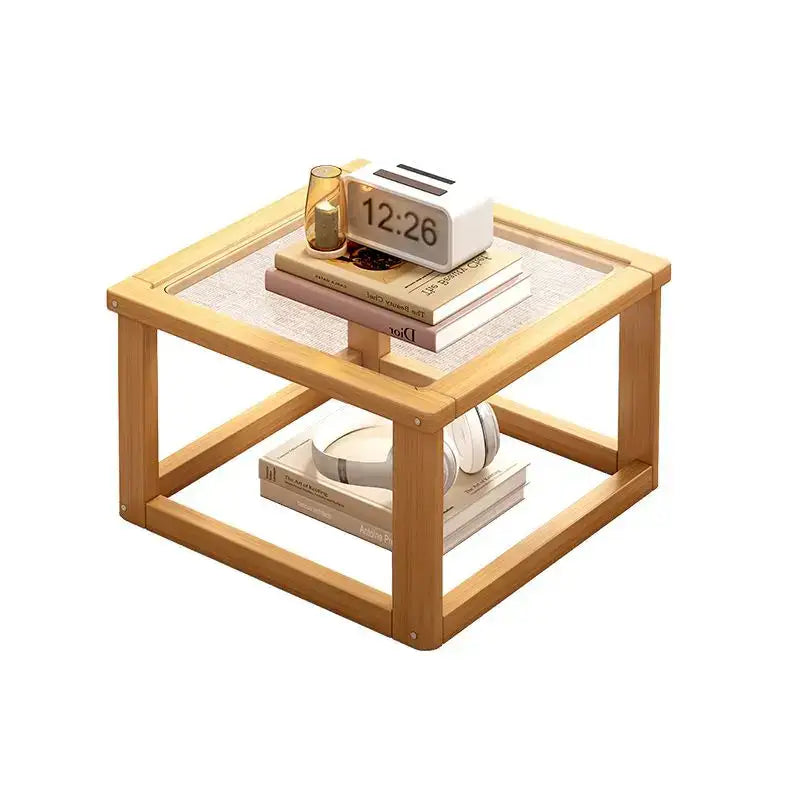 Light wood two tier coffee table set with glass top and open shelving for living room use