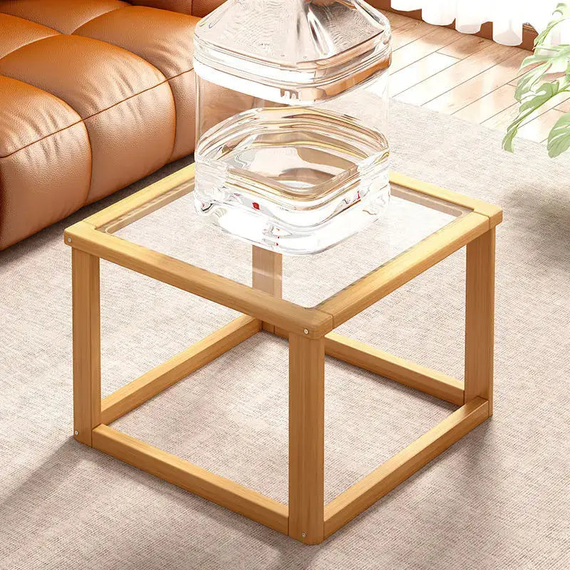 Minimalist light wood coffee table set with clear glass top and open shelving for living room use