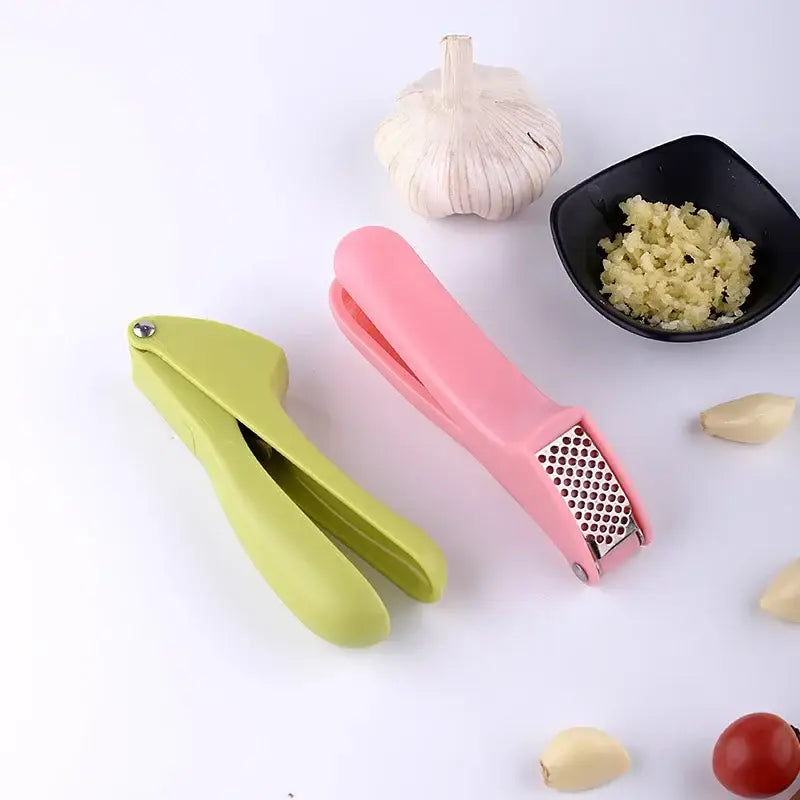 Pink and lime green decorbites garlic rammers with metallic zinc alloy grating surfaces for manual kitchen use